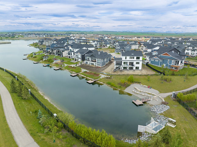 Aerial view of completed lakefront lots and new homes along a residential lake
