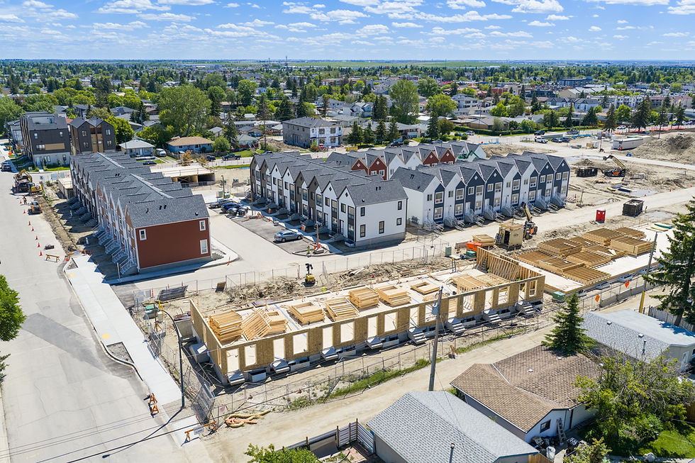 Aerial of new townhouses, some still wood-framed, under construction in Radisson Heights, Calgary