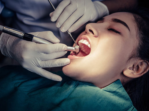 Dentist performs root canal treatment on a patient's tooth.