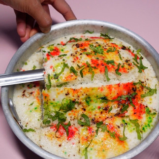 removing the surti idada from the thali using a spatula