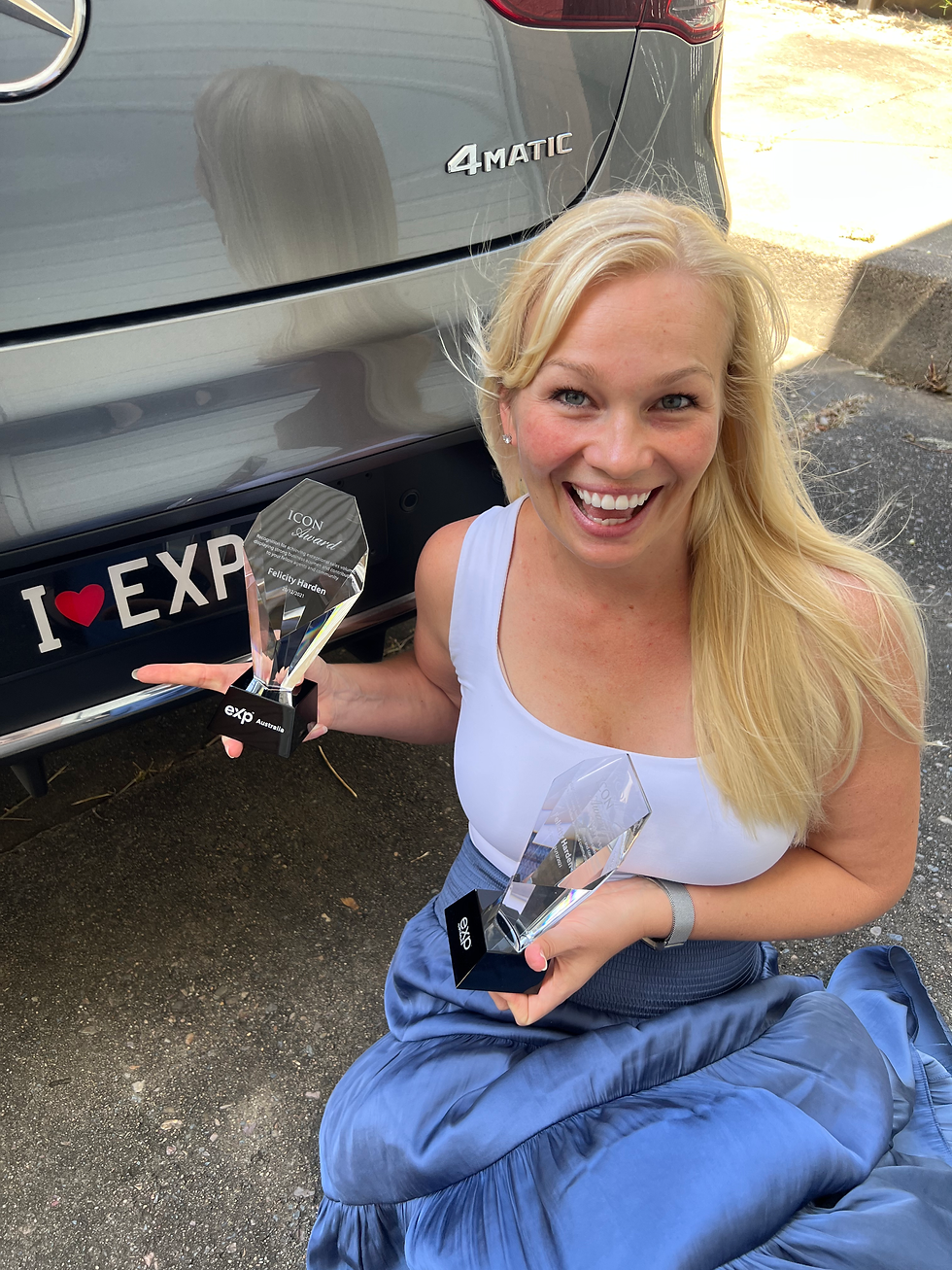 Million dollar agent Felicity harden showing off her 2 x eXp Icon Awards