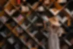 girl wearing hat and bookshelf
