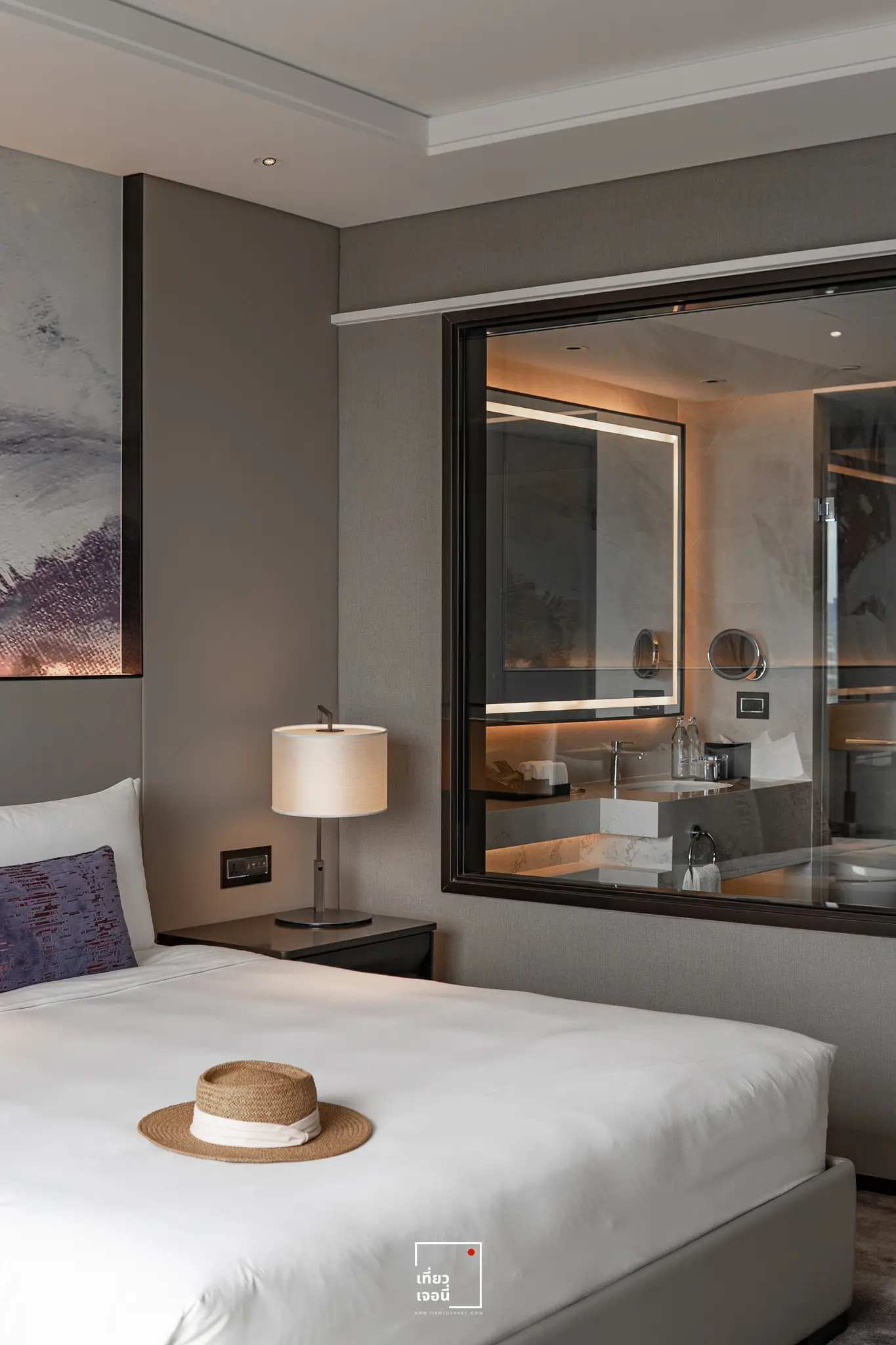 hat on the bed with bathroom window