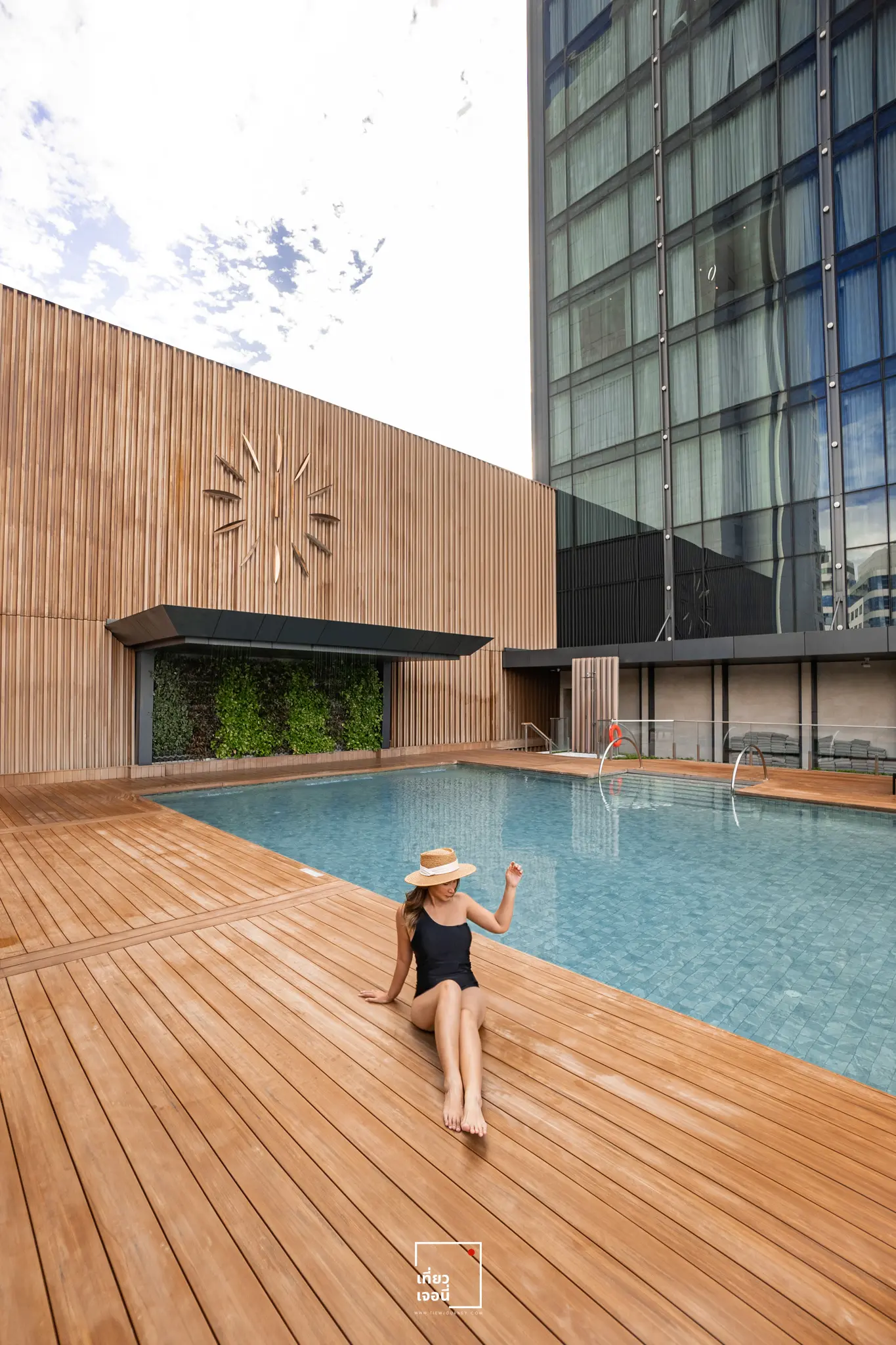 girl sitting beside swimming pool