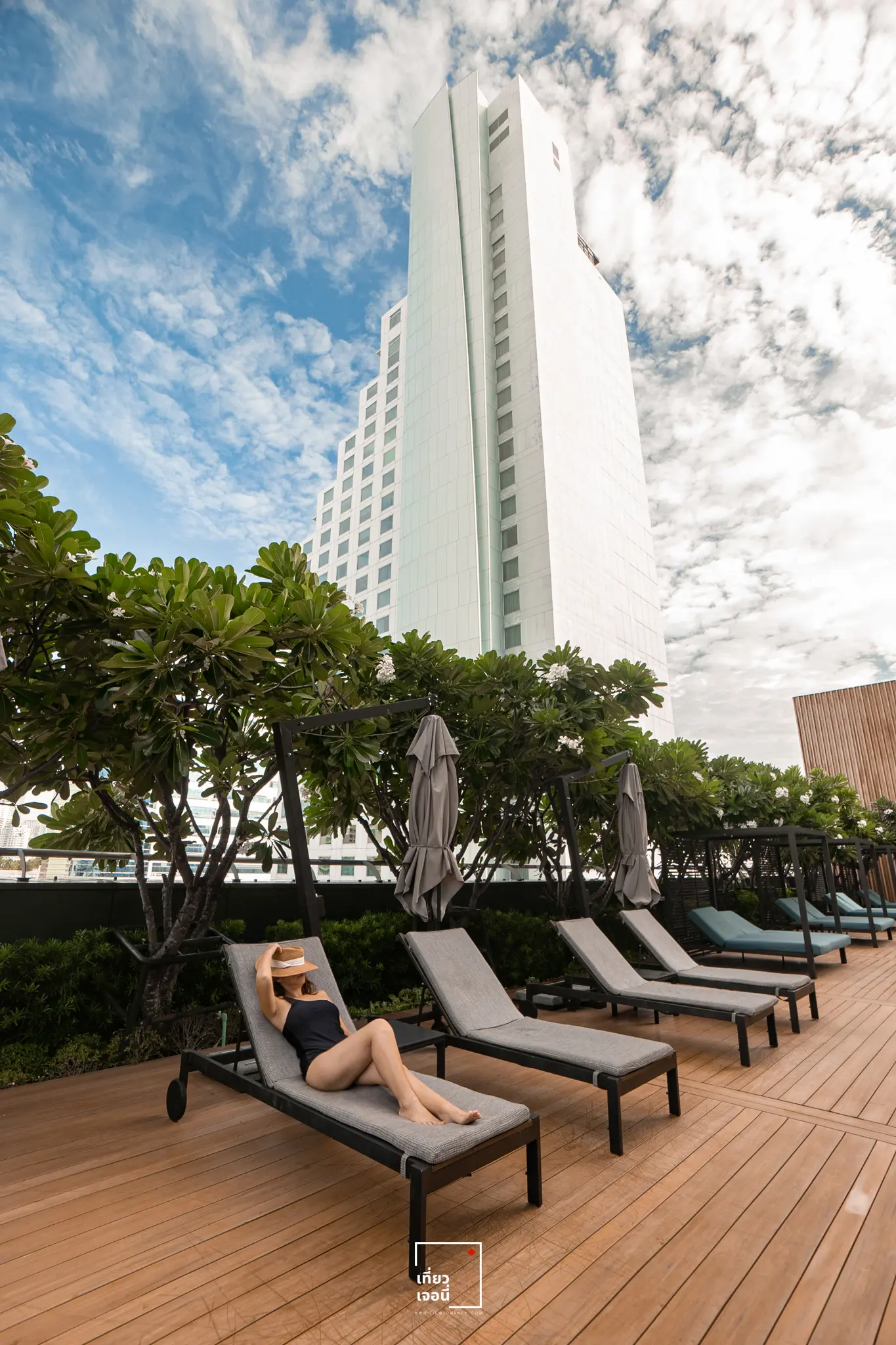 girl lying on the bed beside pool