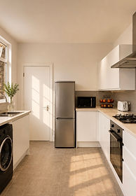 Contemporary kitchen interior with bespoke cabinetry, stone worktops and modern styling