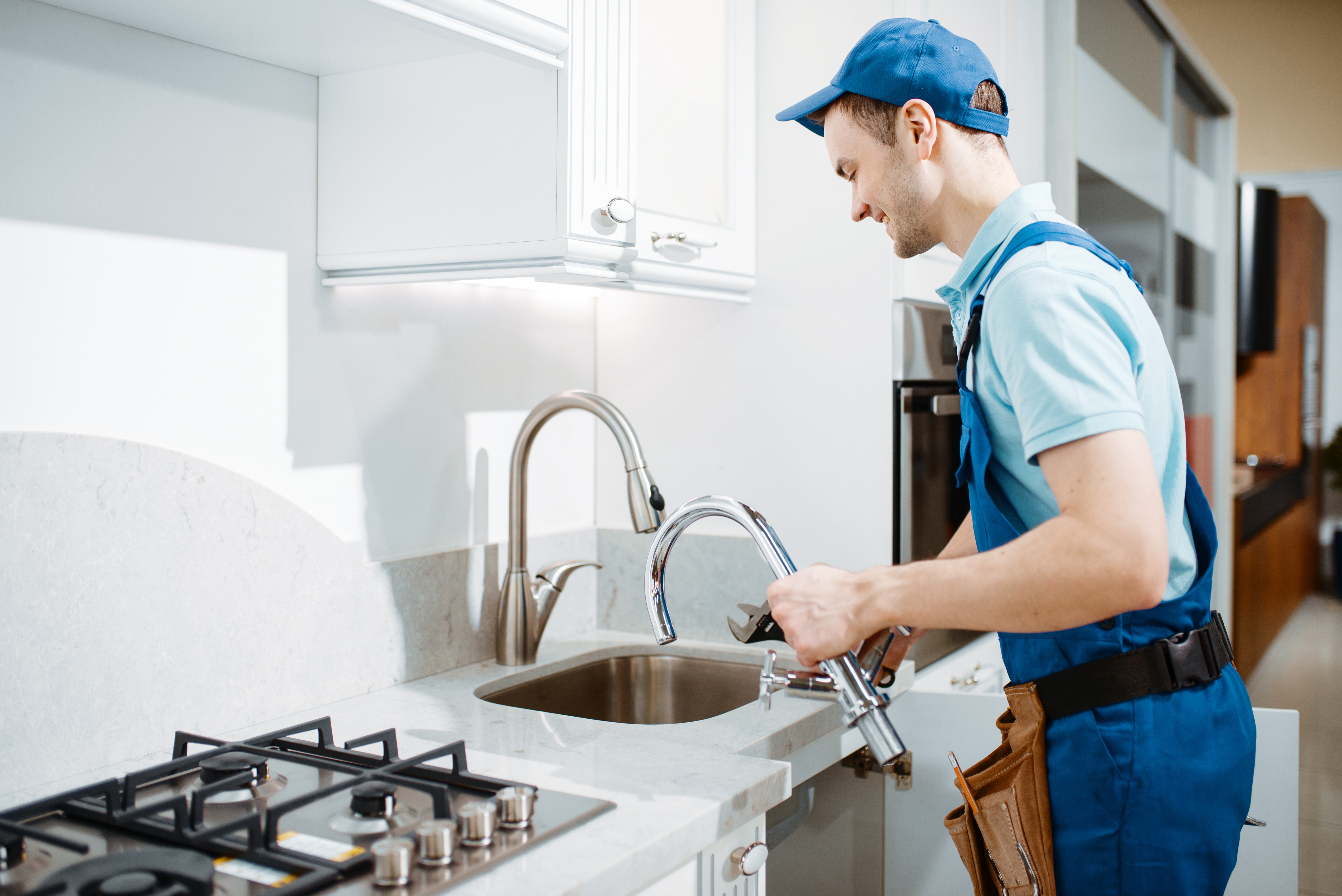 male-plumber-uniform-changes-faucet-kitchen-handyman-with-toolbag-repair-sink-sanitary-equ