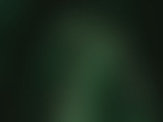 Person standing in the dark with green binary code projected across their face and hands, symbolizing data and artificial intelligence