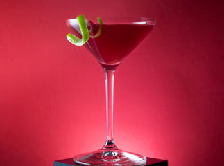 Garibaldi cocktail, Campari and orange juice on red background