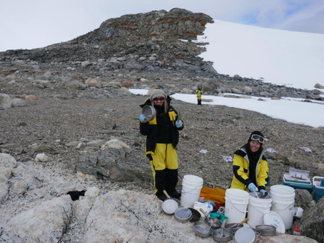 Belinda Ferrari (left) and PhD student Eden Zhang sterilise stainless steel sieves at Mitchell Peninsula, in between sampling. Photo: Cath King