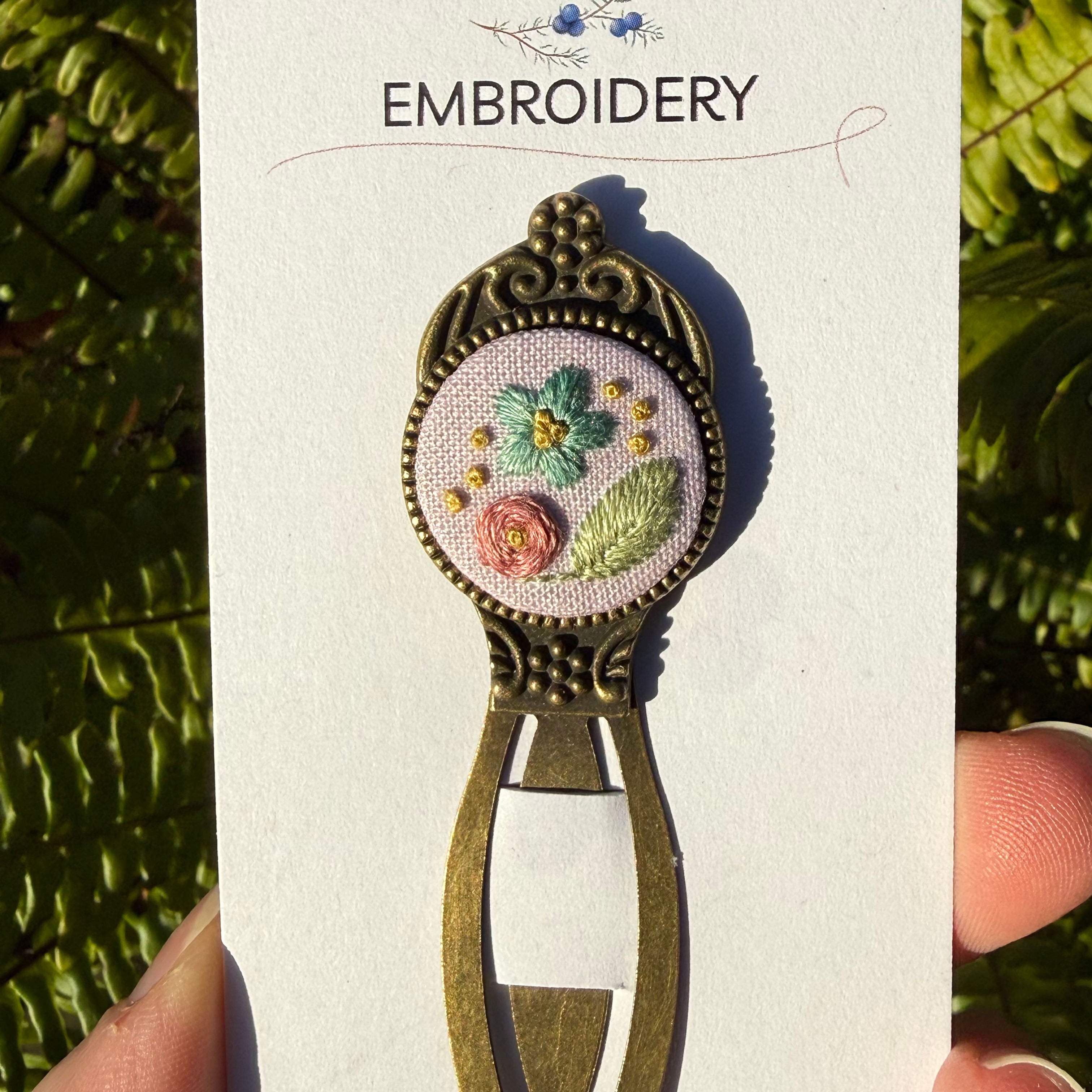 Pink floral hand embroidered bookmark on display card