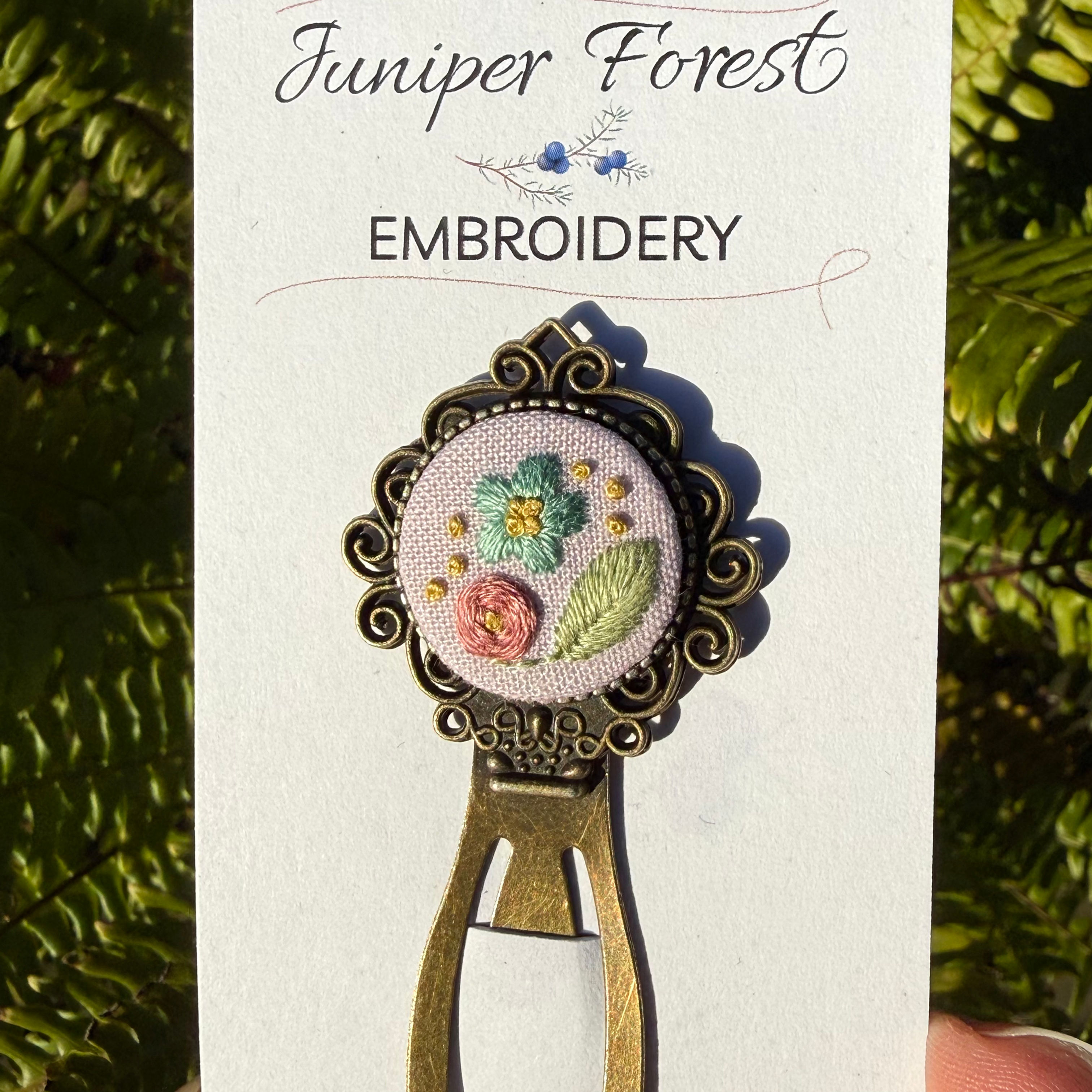 Pink floral hand embroidered bookmark on display card