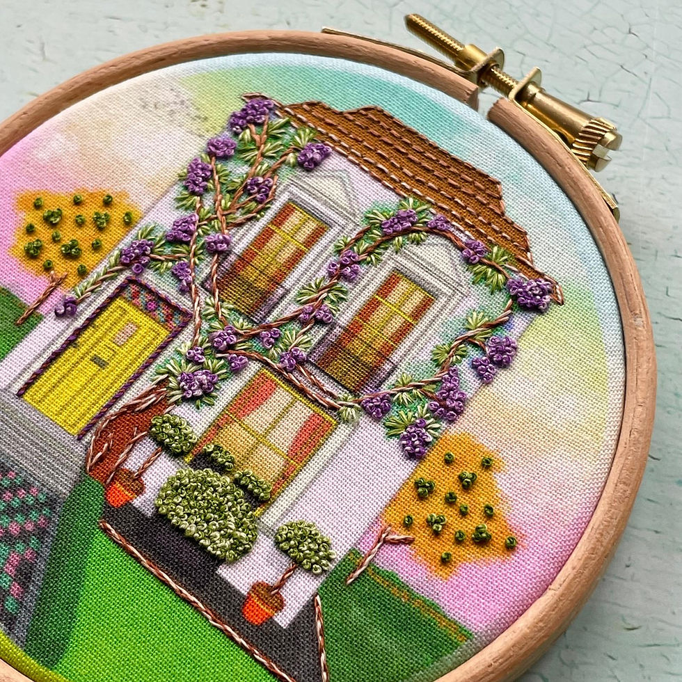 Thumbnail: Close-up of finished wisteria house embroidery design in hoop