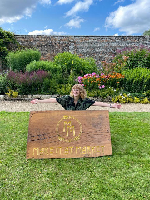 Hannah in front of the Make It At Market promotional logo