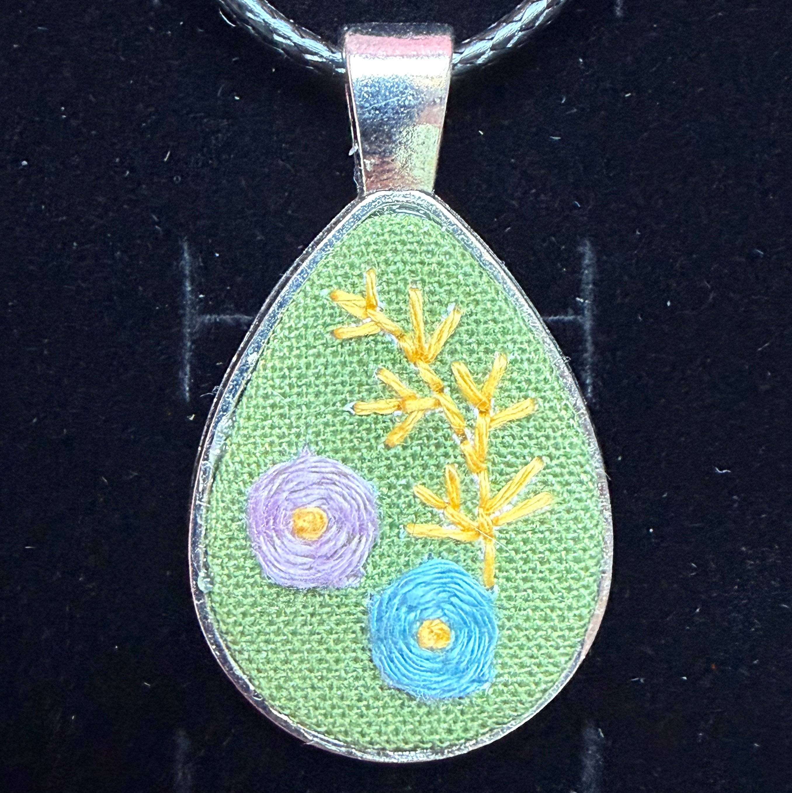 Green floral hand embroidered necklace close-up