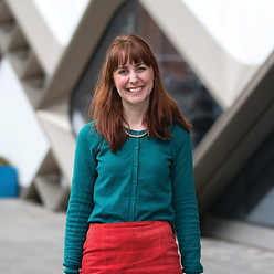 The site owner, Kat Taylor, a white woman with red hair smiles warmly at the camera.