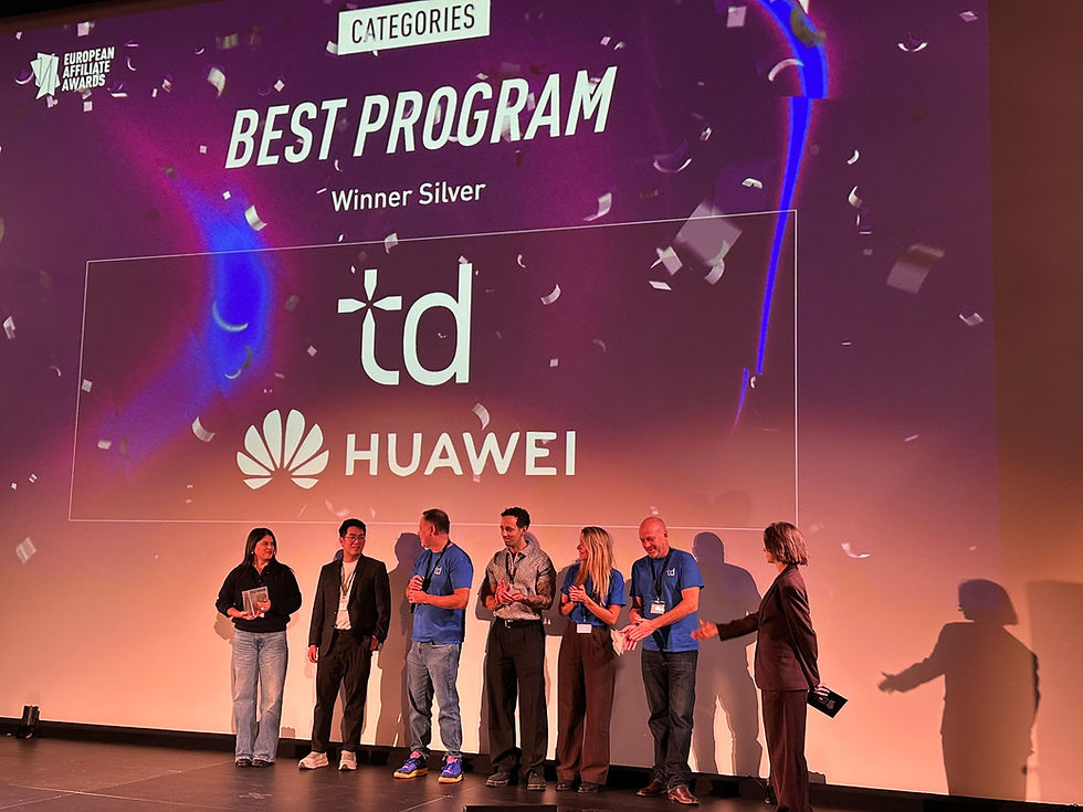 Award stage with confetti and six people applauding beneath a screen reading BEST PROGRAM Winner Silver, td and Huawei logos.