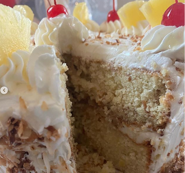 Eye-level view of a coconut cake decorated with shredded coconut