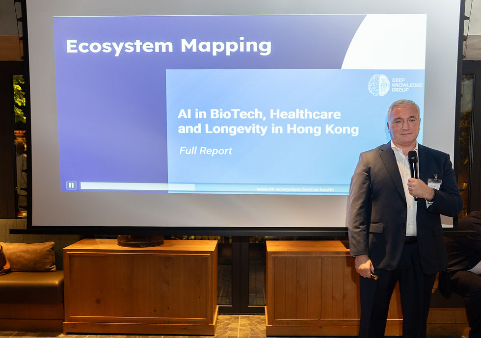 Dmitry Kaminskiy presenting DKG’s AI in BioTech, Healthcare and Longevity in Hong Kong ecosystem mapping materials during the May 2026 Hong Kong visit.