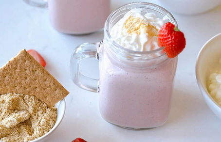 Flat lay, daylight, strawberry smoothie over a white countertop