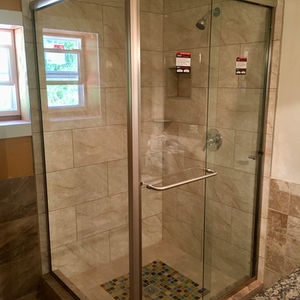 three panel glass bypass shower door enclosure in a bathroom