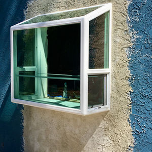 a new garden window with stucco repair