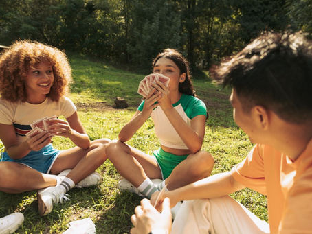 Friends playing cards during summer time