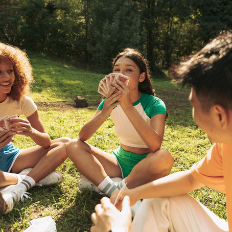Friends playing cards during summer time