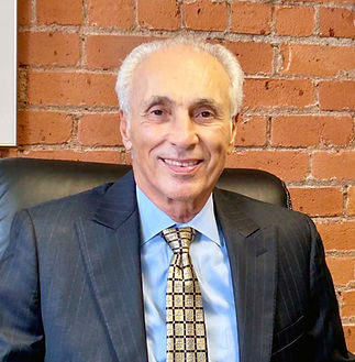 Lou Peters profile in his signature style of suite and tie