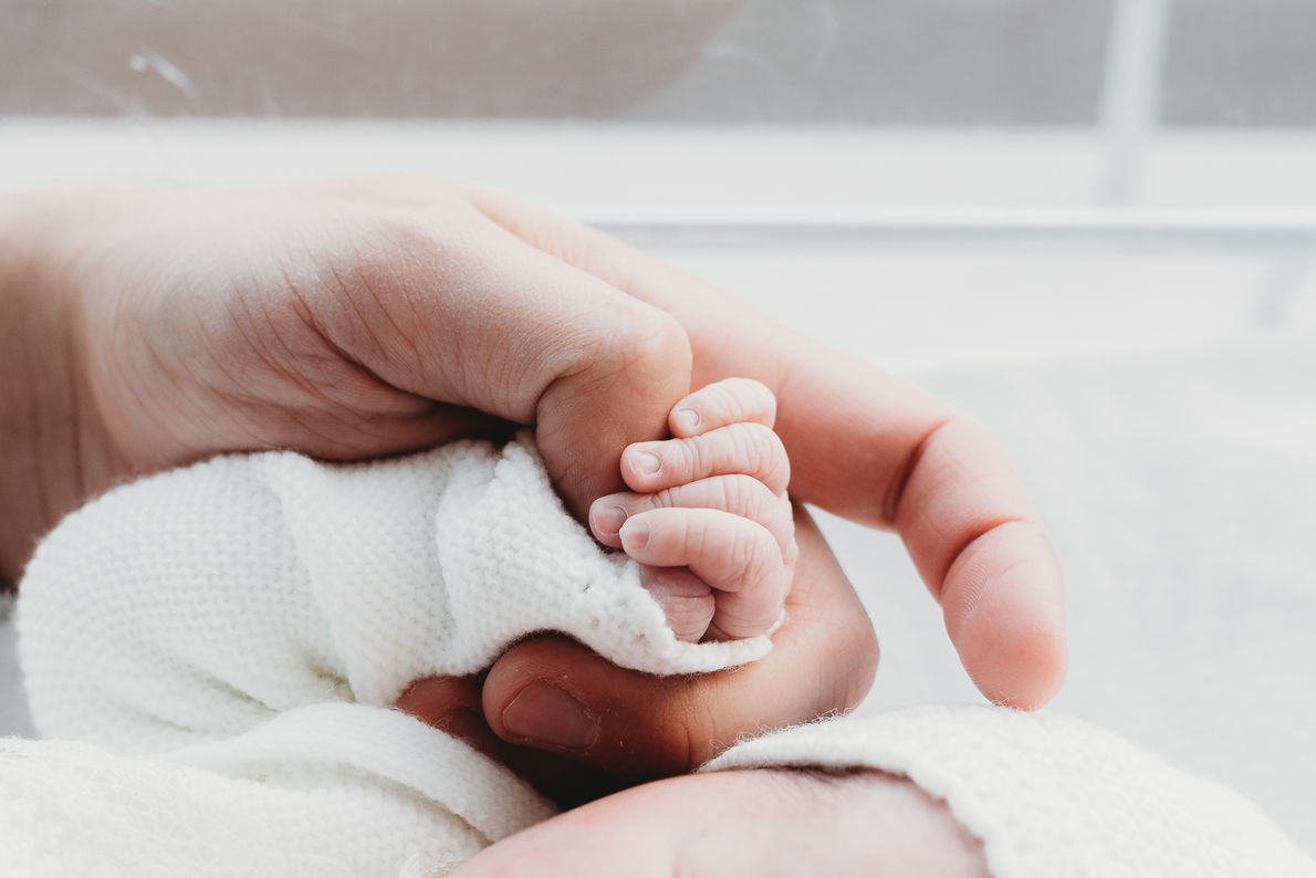 Close up of newborn baby tiny hand, details, wrinkles and tiny features during a hospital newborn photography session in Greater Moncton.