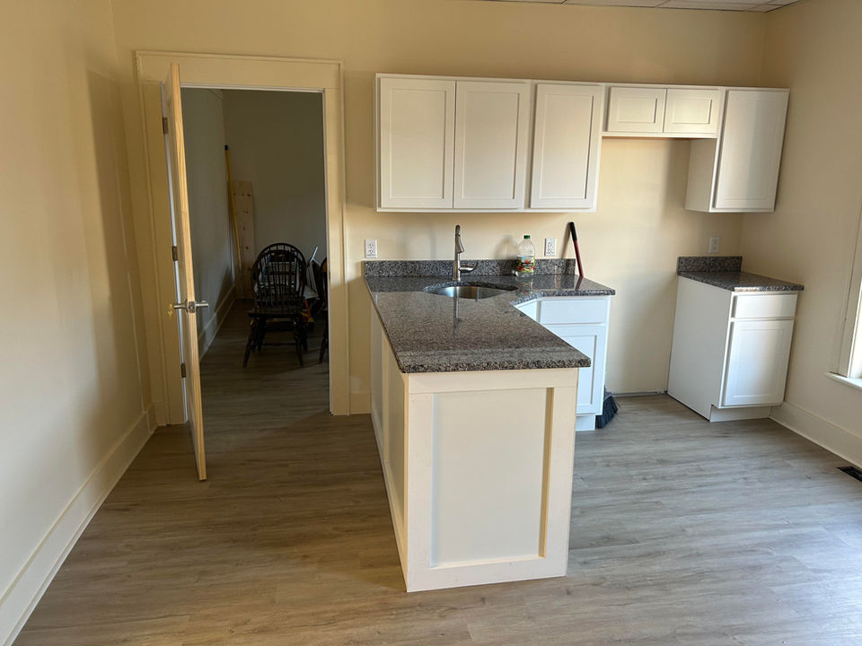 Modern kitchen with granite countertop and white cabinets
