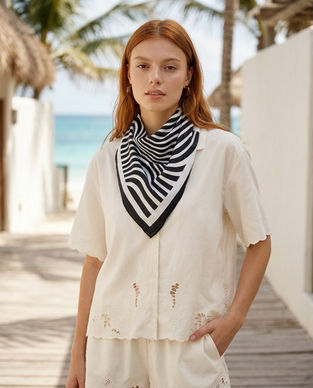 Woman wearing abstract print square scarf