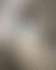 Woman wears blue and white satin scarf as neck scarf