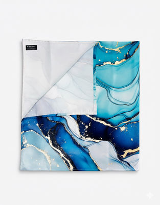 Neatly folded square satin scarf showing cyan and navy marble patterns with gold metallic detailing.