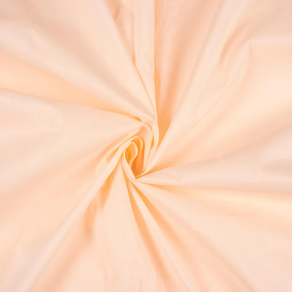 Blush Blossom Plain Cotton Cambric Fabric displayed with a swirl pattern.