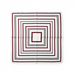 A flat-lay of a square satin bandana showing a burgundy and black concentric geometric design.