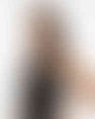 Woman wearing black-copper satin scarf tied at neck (side view).