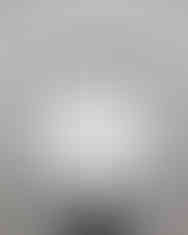 A person holds a white satin scarf with a wide black border.