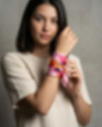 Woman wears satin scarf wrapped around wrist