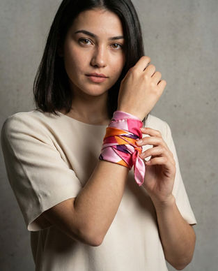 Woman wears satin scarf wrapped around wrist