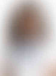 Woman wearing navy blue and white striped satin scarf, neck knot