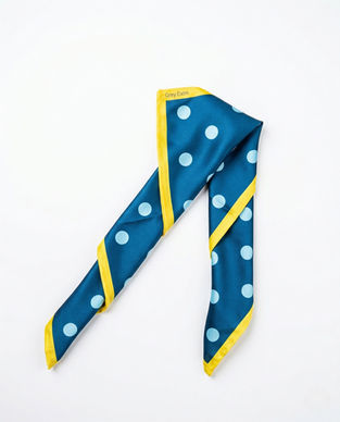 Teal polka dot satin scarf folded in inverted V shape.