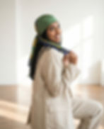 Woman wearing olive green constellation print square scarf as headscarf