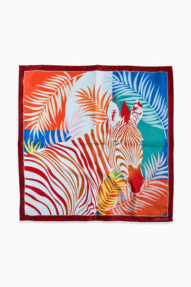A close-up of a satin bandana with a colorful zebra and tropical leaf print.