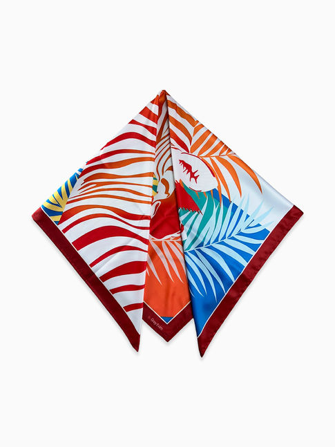 A colorful zebra and palm leaf print scarf folded into a triangle.