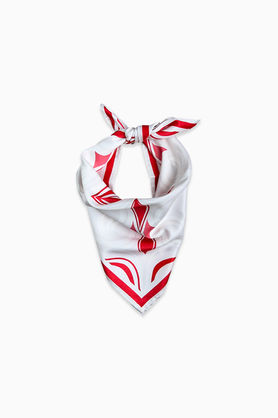 A white and red abstract print bandana tied in a knot.