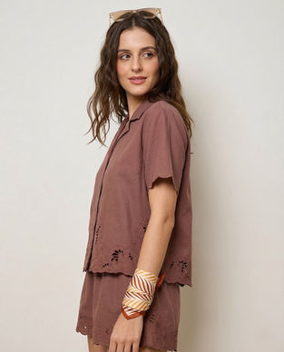 Woman wears satin scarf tied on wrist with stripe pattern