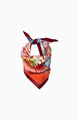A colorful zebra and palm leaf print bandana tied in a knot.