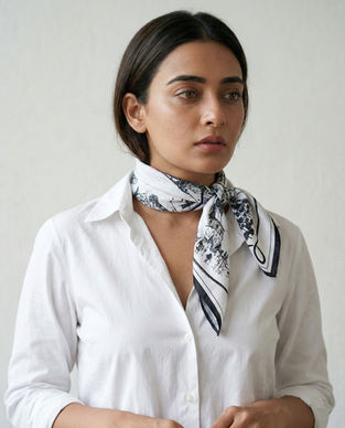 Woman wears black white architectural cotton scarf neck style