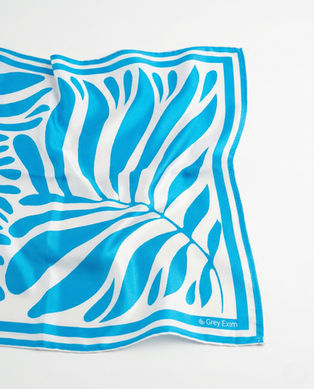 Close-up of blue and white leaf print satin scarf